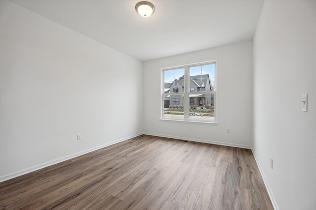 empty room with wood-type flooring