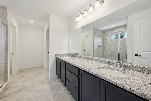 bathroom with tile patterned floors, vanity, and a shower with shower door