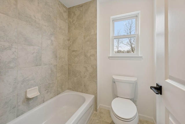 bathroom with tile patterned flooring, tiled shower / bath combo, and toilet