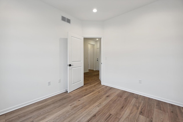 unfurnished room with light wood-type flooring