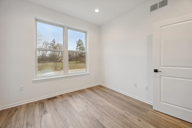 unfurnished room with light wood-type flooring