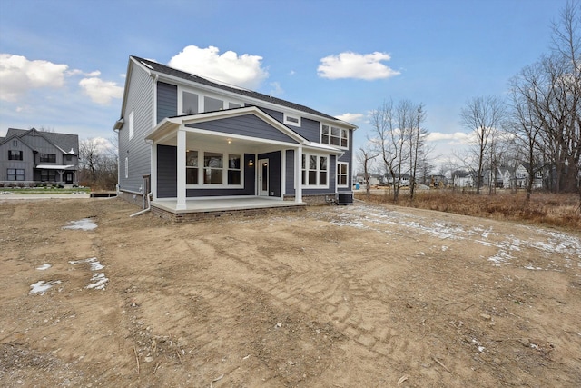 rear view of house with a patio area and central AC unit