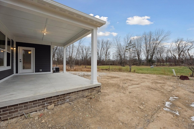 view of yard with cooling unit and a patio area