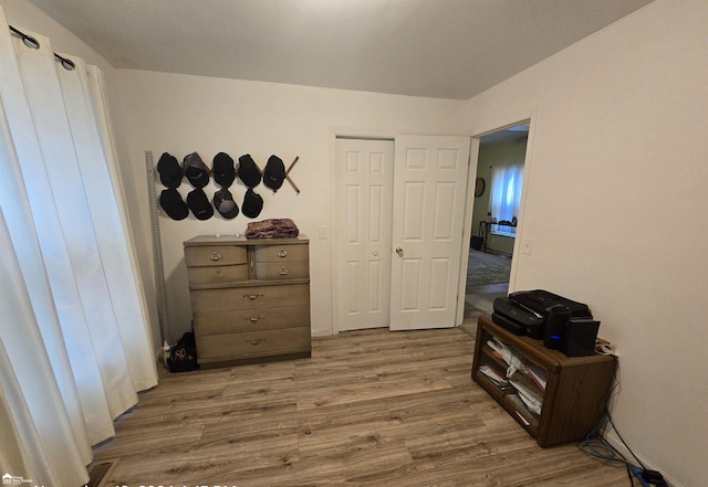 bedroom with a closet and light hardwood / wood-style floors