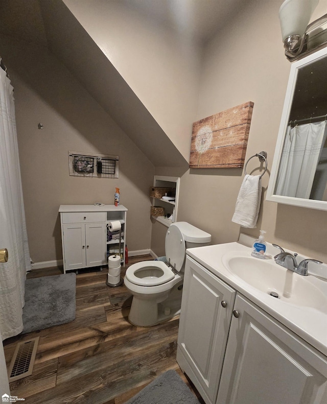 bathroom with hardwood / wood-style floors, vanity, and toilet