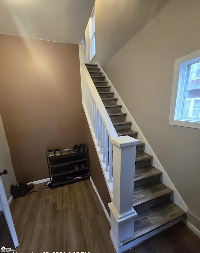 stairs featuring wood-type flooring