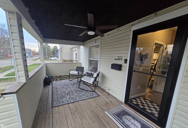 wooden terrace featuring ceiling fan and covered porch