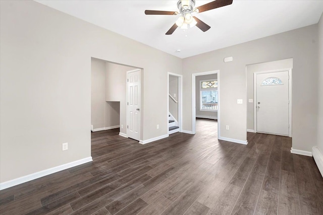 interior space with ceiling fan and dark hardwood / wood-style floors