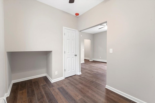 spare room featuring ceiling fan and dark wood-type flooring