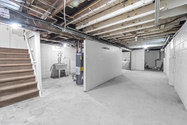 basement featuring gas water heater and sink