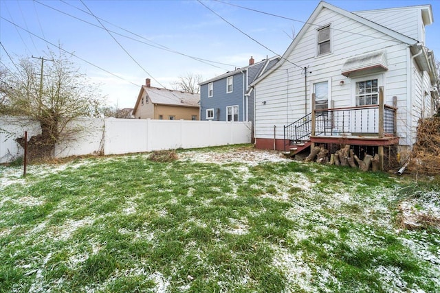 snow covered back of property featuring a yard