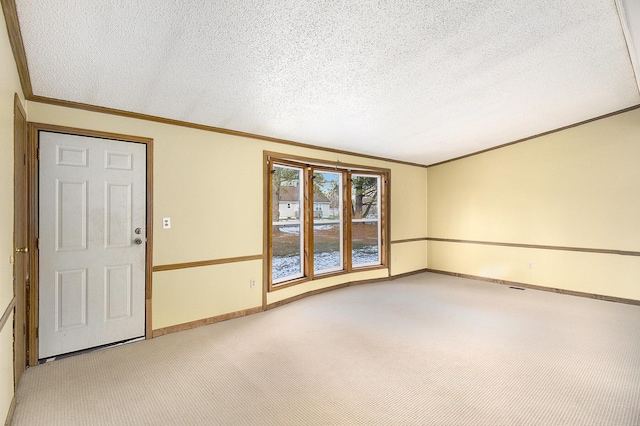 unfurnished room featuring crown molding, carpet floors, and a textured ceiling