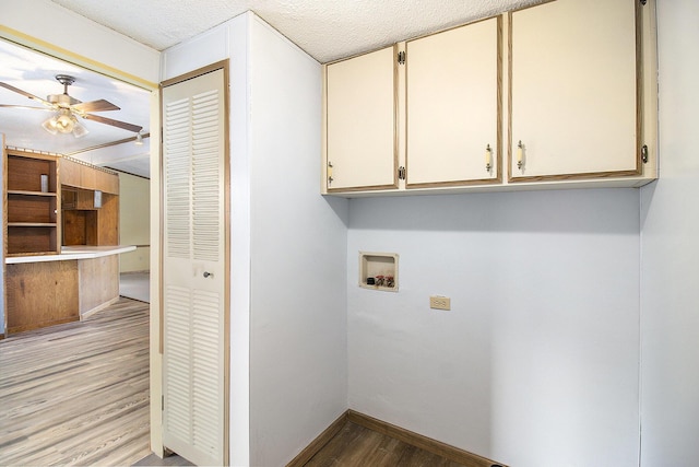 laundry area featuring cabinets, washer hookup, light wood-type flooring, a textured ceiling, and ceiling fan