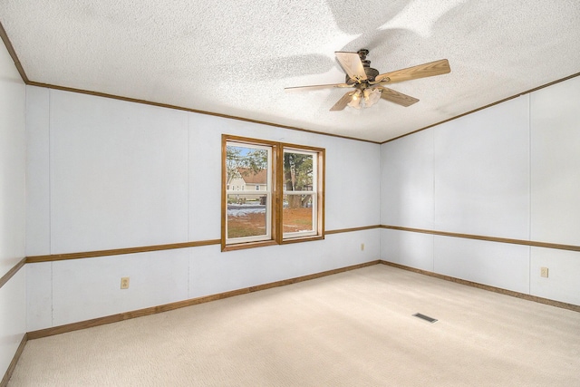 carpeted spare room with ceiling fan and a textured ceiling