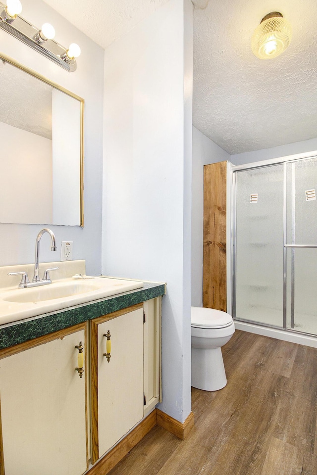 bathroom featuring vanity, a textured ceiling, and hardwood / wood-style flooring