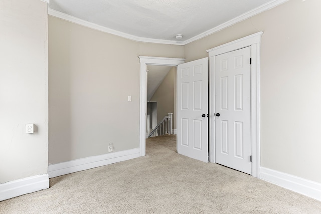 unfurnished bedroom with crown molding and light carpet