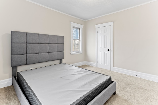 carpeted bedroom with a textured ceiling and ornamental molding