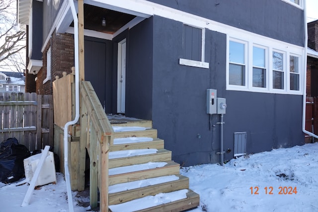 view of snow covered property entrance