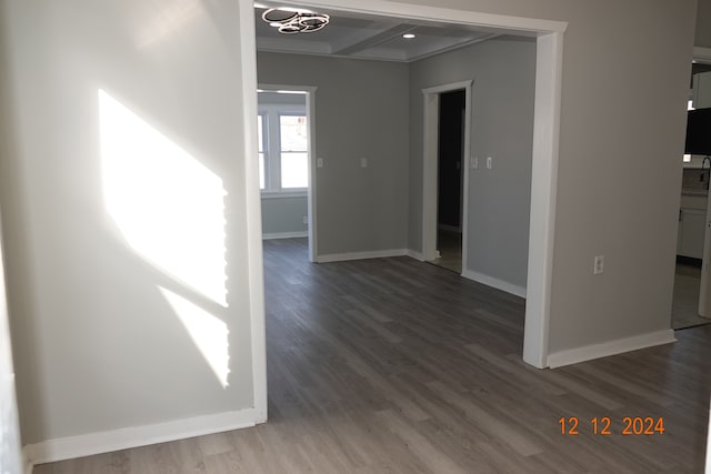 spare room with beamed ceiling, dark hardwood / wood-style floors, and ornamental molding