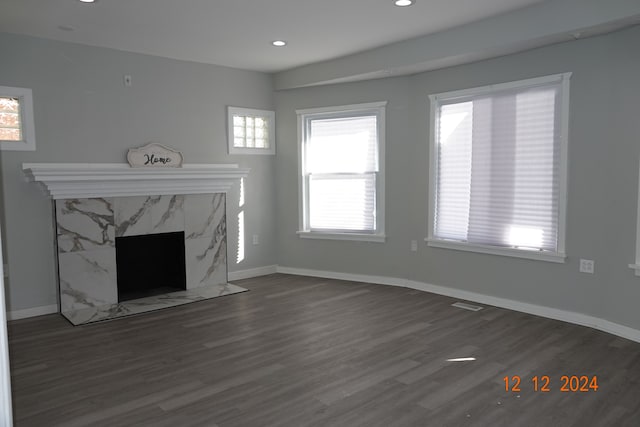 unfurnished living room featuring dark hardwood / wood-style floors and a fireplace