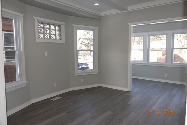 unfurnished room with beamed ceiling, crown molding, dark wood-type flooring, and a wealth of natural light