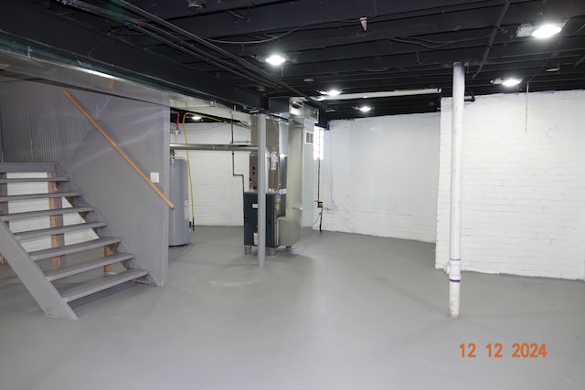 basement featuring heating unit and water heater