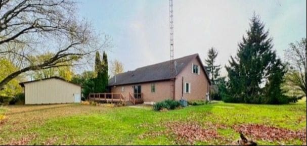 view of side of home with a lawn