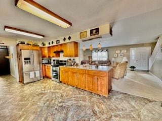 kitchen with kitchen peninsula, extractor fan, white fridge with ice dispenser, and stainless steel range with electric stovetop