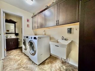 washroom featuring cabinets, separate washer and dryer, and sink