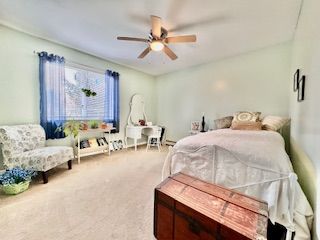 carpeted bedroom featuring ceiling fan