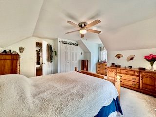 bedroom featuring vaulted ceiling and ceiling fan