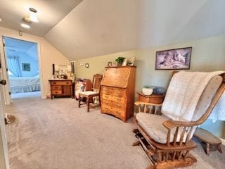 sitting room featuring vaulted ceiling and carpet floors