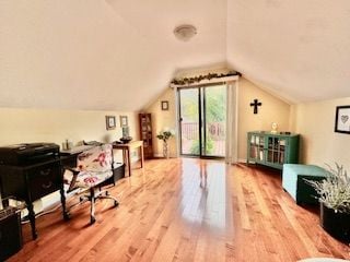 office area featuring hardwood / wood-style floors and vaulted ceiling