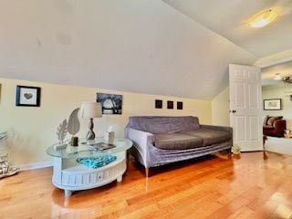 sitting room with hardwood / wood-style flooring and lofted ceiling