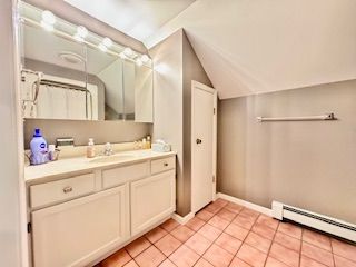 bathroom featuring tile patterned floors, vanity, and a baseboard radiator