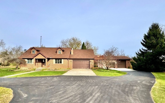 view of front facade with a front yard and a garage