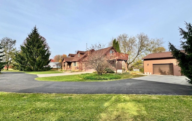 view of front of house with a front yard and a garage