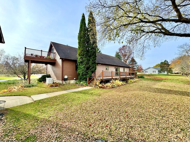 exterior space featuring a deck and a lawn