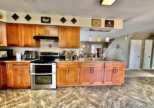 kitchen with decorative light fixtures and range with two ovens