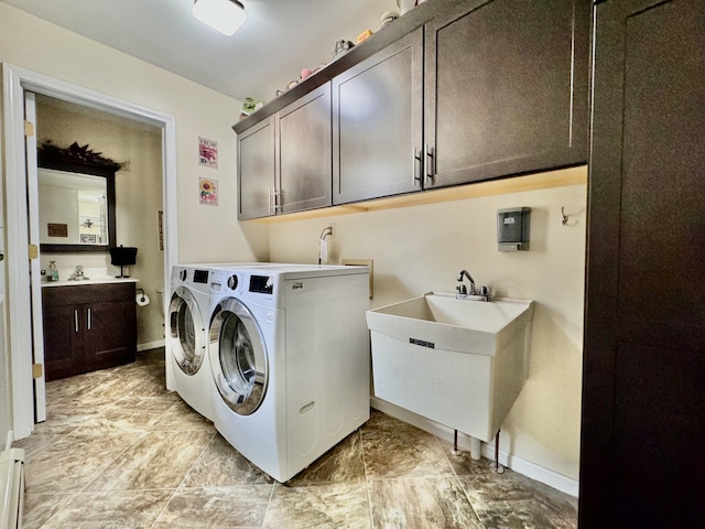 washroom featuring cabinets, independent washer and dryer, and sink