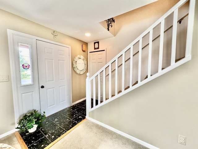 entryway with dark colored carpet