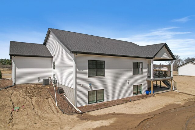 12711 Ivy Ln, Linden, MI 48451 - view of property exterior featuring a deck and roof with shingles