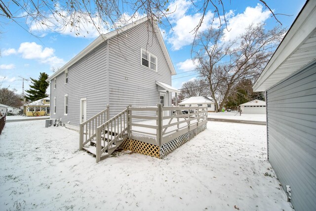 view of snowy exterior featuring a deck