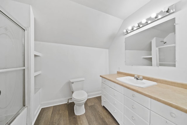 bathroom with lofted ceiling, toilet, vanity, and hardwood / wood-style floors