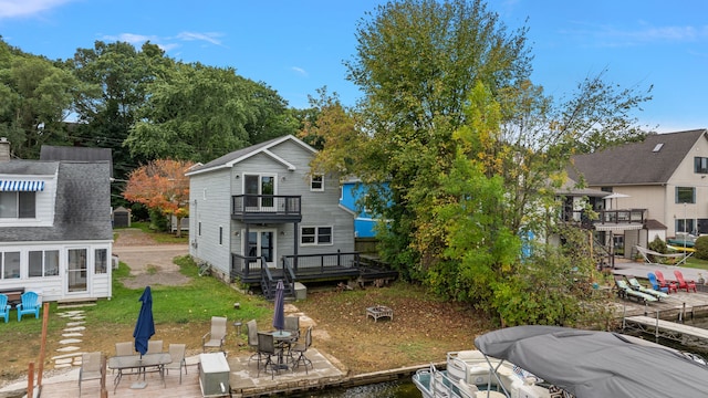 back of house featuring a patio area, a deck, and a balcony