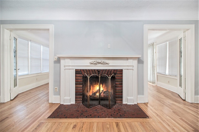 details featuring wood-type flooring and a brick fireplace