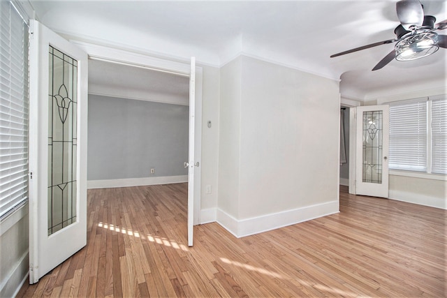 unfurnished room featuring light wood-type flooring, ceiling fan, and crown molding