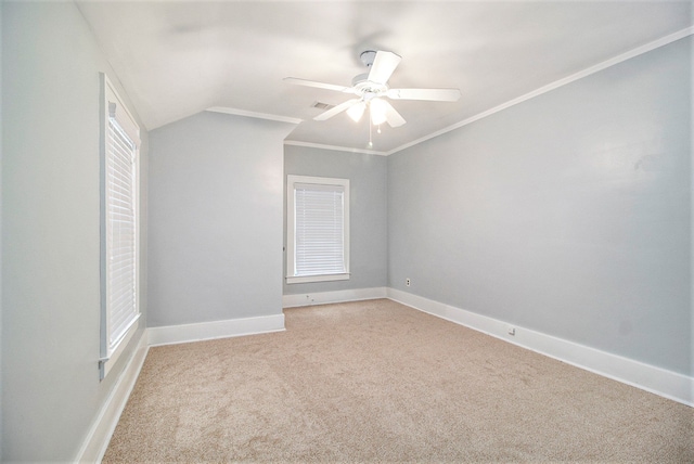 empty room featuring light carpet, ceiling fan, lofted ceiling, and ornamental molding