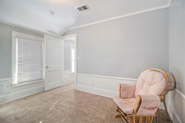 living area featuring carpet flooring, crown molding, and vaulted ceiling