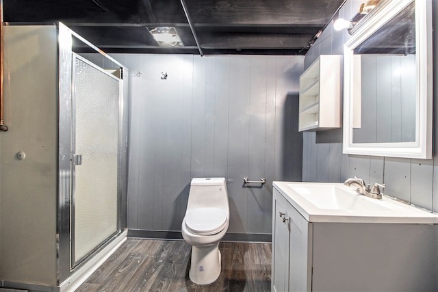 bathroom featuring wooden walls, toilet, an enclosed shower, and hardwood / wood-style flooring